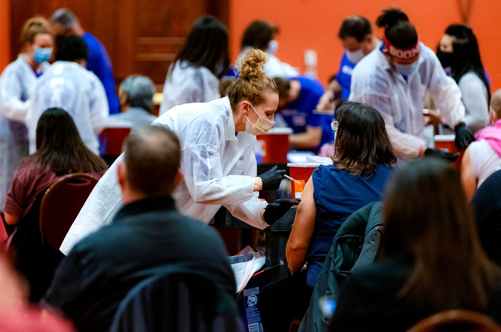 Members of IMMY Labs administer inoculations during a Covid-19 vaccination pod at the Embassy Suites by Hilton Norman Hotel & Conference Center in Norman, Okla. on Monday, Feb. 22, 2021.  [Chris Landsberger/The Oklahoman] 