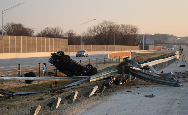 A car lays inverted along I-69 in Martinsville early Thursday morning.