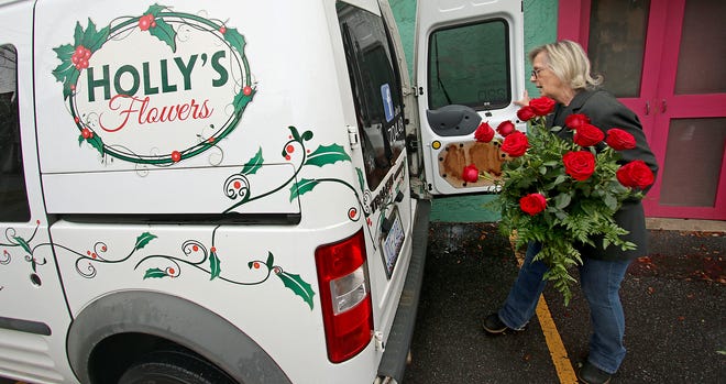 Owner Holly Brock loads a van with flowers to be delivered Thursday morning, March 10, 2022, at Holly’s Flowers on East Graham Street in Shelby.