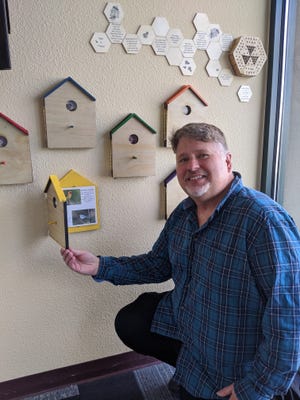 David Chapman, manager of the Silver City Visitor Center, shows one of the new bird and pollinator interpretive stations.