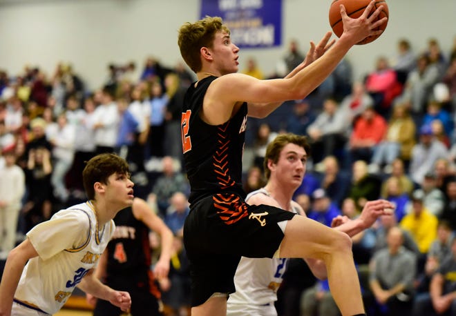 Almont's Clay Roszczewski goes for a layup during a game last season. He was voted Blue Water Area Athlete of the Week on Thursday.