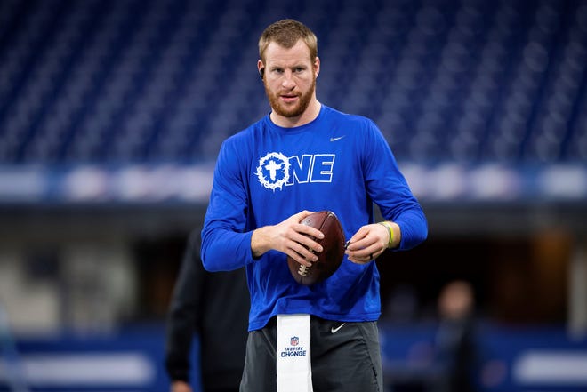 FILE - Indianapolis Colts quarterback Carson Wentz (2) warms up on the field before an NFL football game against the Las Vegas Raiders, Sunday, Jan. 2, 2022, in Indianapolis. The Washington Commanders have agreed to acquire quarterback Carson Wentz from the Indianapolis Colts, according to a person with direct knowledge of the situation. The person spoke to The Associated Press on condition of anonymity Wednesday, March 9, 2022, because the deal cannot be finalized until the start of the new league year next week. (AP Photo/Zach Bolinger, File)