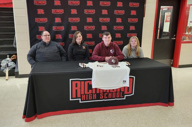 Richmond senior Hayden Scalf smiles with his family after committing to play baseball at Earlham College March 9, 2022.