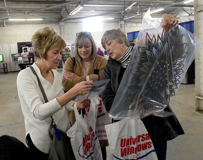 Luan Korosa, left, Jill Lehman and Dian Verbosky shop at Levengood Company during a visit Friday at the Stark County Home & Garden Show at the Stark County Fairgrounds.