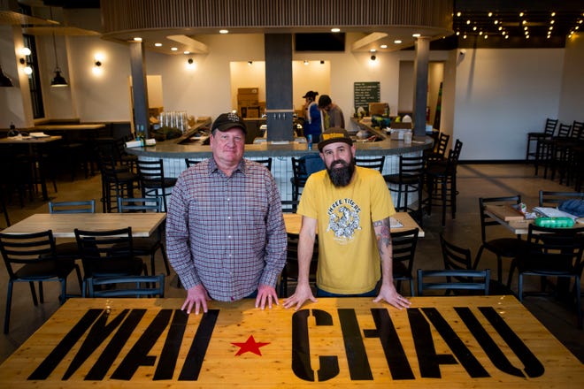 Owners Lonnie Hill (left) and Scott Wilkins (Rick Moller is the other owner not shown) stand in the dining area of the new Three Tigers Brewing Mai Chau Kitchen location on North Prospect Street in Granville, Ohio on March 10, 2022. The new brewery and restaurant will be located in the old Granville Fire Department across the street from the current location. The new location is set to open sometime this spring.
