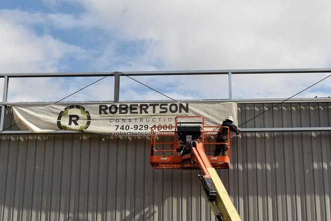 A Robertson Construction crew works on a speculative building on James Parkway in Heath on the Central Ohio Aerospace and Technology Center campus. Robertson Construction recently celebrated 25 years in business.