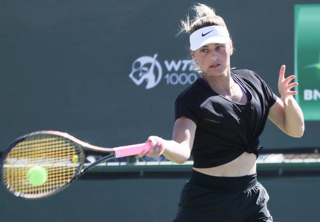 Marta Kostyuk hits balls during a practice session at the BNP Paribas Open in Indian Wells, Calif., March 11, 2022.