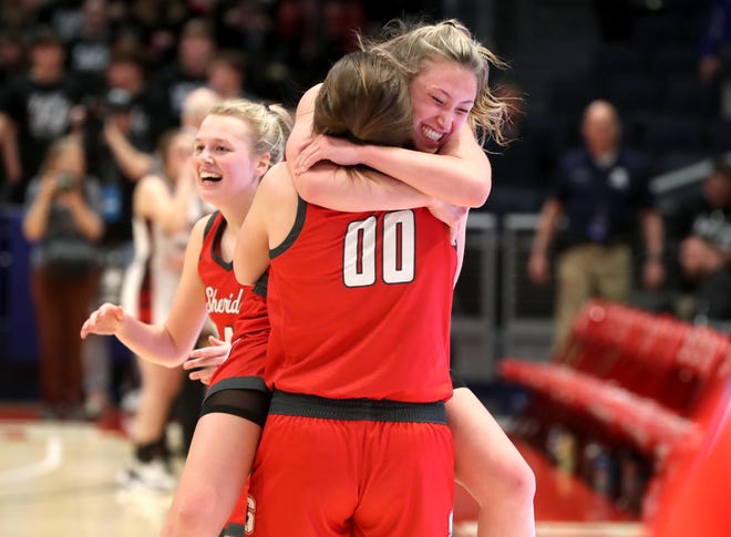 Sheridan's Bailey Beckstedt, facing, leaps into the arms of teammate Faith Stinson as they celebrate a 68-60 triple overtime win against Norton in an OHSAA Division II state semifinal March 10 at UD Arena in Dayton. Sheridan held Norton scoreless in the third overtime to advance to the state championship game Saturday.