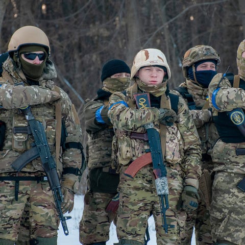 Ukrainian servicemen gesture during a training ses