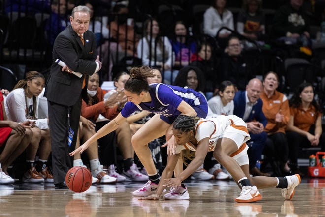Texas guard Aliyah Matharu and Kansas State's Jaelyn Glenn fight for a loose ball during the first half of the Longhorns' 72-65 win Friday night in the Big 12 Tournament quarterfinals. Texas meets Iowa State in Saturday's semifinals.