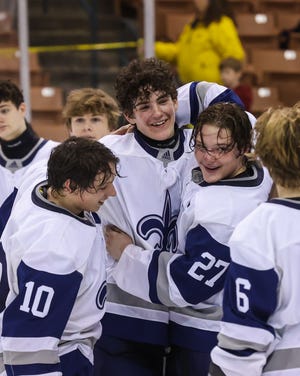 From left, St. Thomas Aquinas' Colin Chrisom, Lincoln Stone and Max Murray celebrate after Saturday's Division II boys hockey championship win over Portsmouth/Newmarket at Southern New Hampshire University Arena in Manchester.