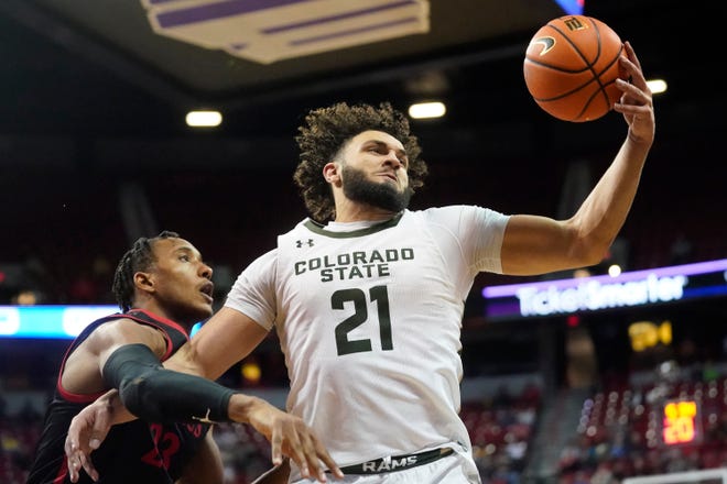 San Diego State forward Joshua Tomaic, right, defends against Colorado State guard David Roddy (21) during the second half of an NCAA college basketball game in Mountain West Conference men's tournament semifinals on Friday, March 11, 2022 in Las Vegas.  (AP Photo/Rick Bowmer)