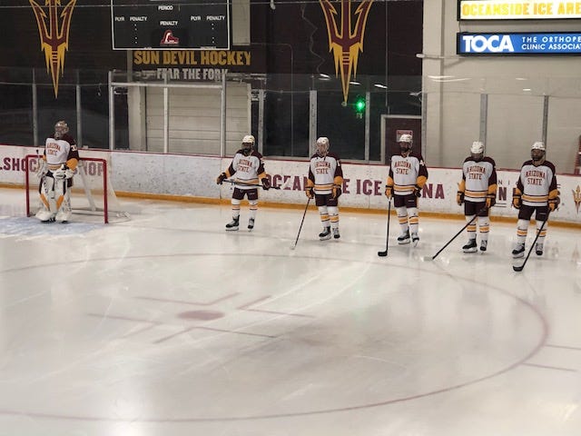 Arizona State Sun Devils hockey players stand along the end line at Oceanside Ice Arena before Friday's game against Long Island University.