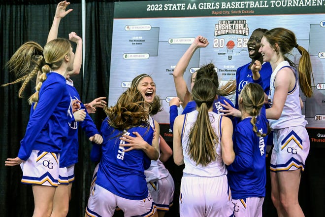 Sioux Falls O'Gorman celebrates after placing their team name sticker onto the tournament board following a 50-37 win over Brandon Valley during a game in the championship semifinals of the girls Class AA state championships on Friday at The Monument Ice Arena in Rapid City.