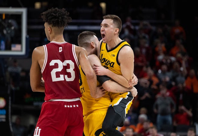 Iowa Hawkeyes guard Jordan Bohannon (3) celebrates hitting the game winning basket with guard Connor McCaffery (30) in the second half against the Indiana Hoosiers at Gainbridge Fieldhouse.