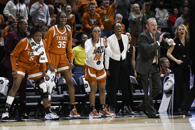 Texas coach Vic Schaefer and his bench celebrate a play during this past season's game with Baylor in the Big 12 Tournament championship game in Kansas City. The Longhorns' 2022-23 season begins Nov. 11.