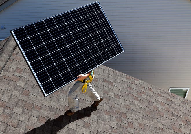 A solar panel is installed on the roof of a home.