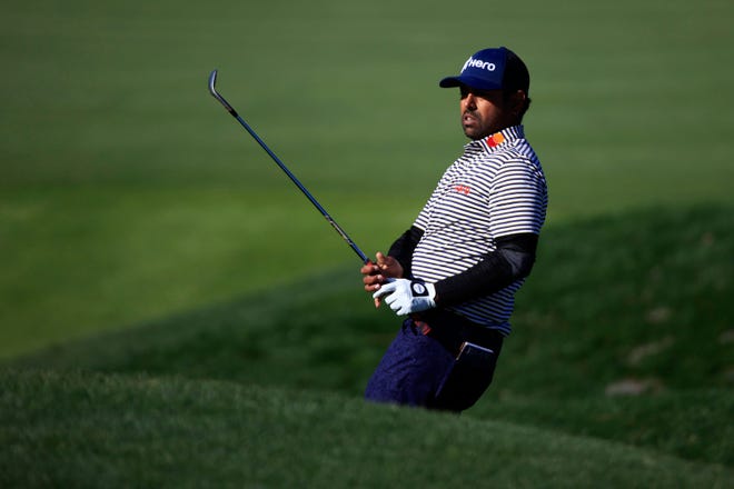 Anirban Lahiri reacts to his chip shot on the second hole of the Players Stadium Course Sunday on his way to taking The Players Championship lead heading into Monday's action.