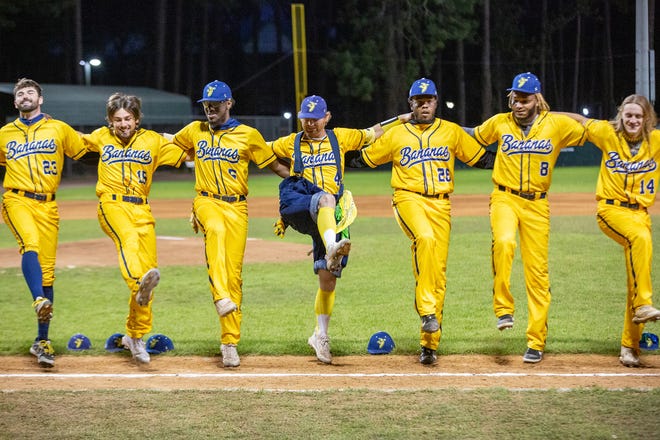 Mat Wolf (4, in blue suspenders and wide pants) dances on the shot line with his teammates at the Savannah Bananas Premier Team on March 12, 2022, at Grayson Stadium, before the match against Party Animals.  Also pictured on the left are Collin Ledbetter (23) right pitcher, William Kwasigroh outside player / LHP (14) Stephen Felton (5) inside player, Alex Pierce (26) and Aderlyn Silverio (8) right pitcher and RHP / utility.  Dakota 
