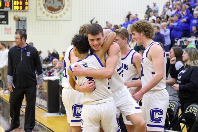 Jake Skinner embraces Chris Huerta as Carroll celebrates its first regional championship by knocking off No. 1 Monroe Central.