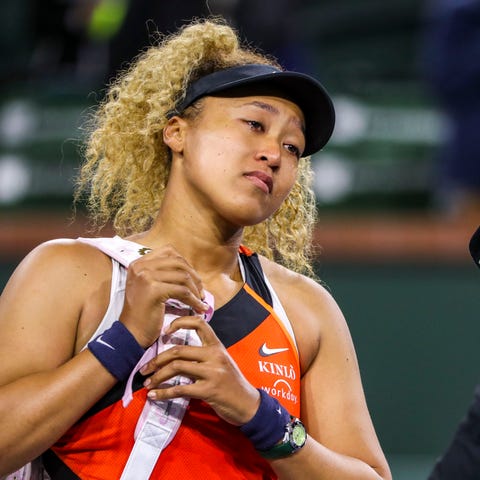 Naomi Osaka of Japan addresses the crowd about bei