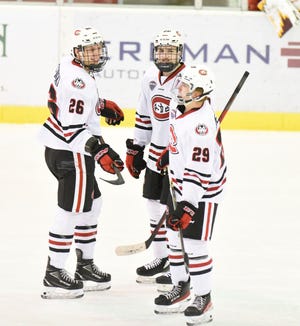 St. Cloud State seniors Easton Brodzinski and Nolan Walker talk to sophomore Veeti Miettinen during a break in the action Saturday, March 12, 2022, at Herb Brooks National Hockey Center in St. Cloud.