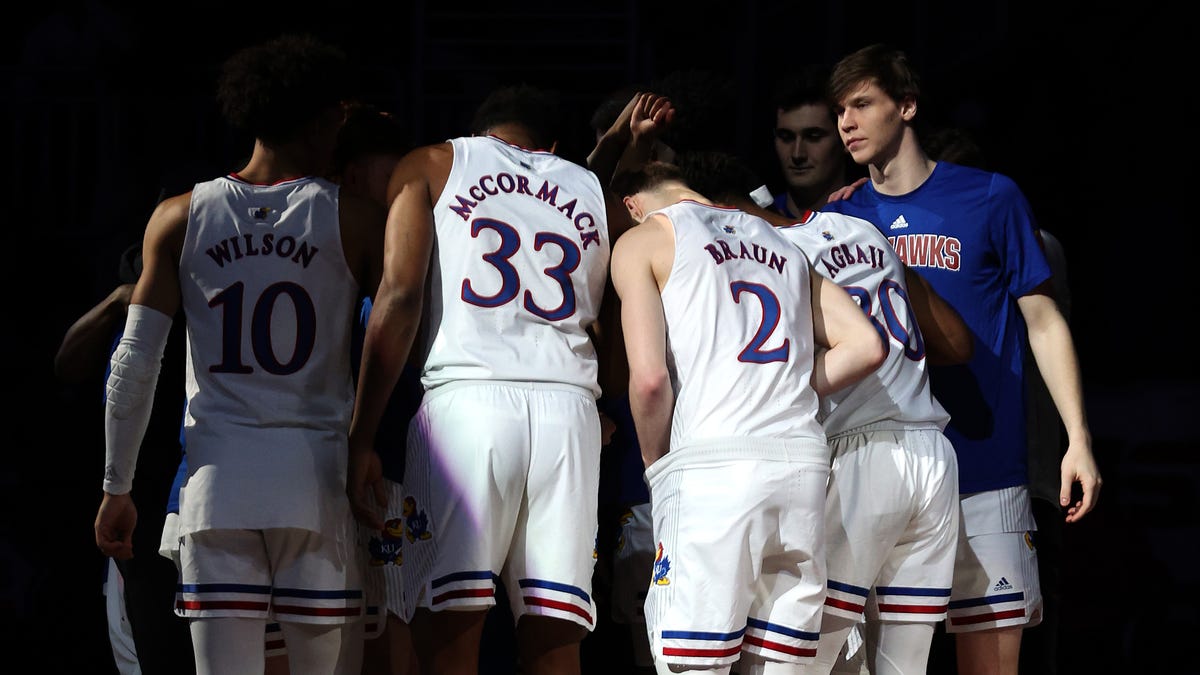 The Kansas Jayhawks huddle prior to a game against the Texas Tech Red Raiders during the finals of the 2022 Phillips 66 Big 12 Men's Basketball Championship at T-Mobile Center.