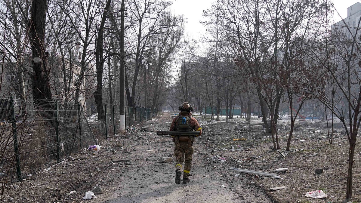 A Ukrainian serviceman walks near the position he was guarding in Mariupol, Ukraine, Saturday, March 12, 2022. Ukraineâ€™s military says Russian forces have captured the eastern outskirts of the besieged city of Mariupol. In a Facebook update Saturday, the military said the capture of Mariupol and Severodonetsk in the east were a priority for Russian forces. Mariupol has been under siege for over a week, with no electricity, gas or water.(AP Photo/Evgeniy   Maloletka)