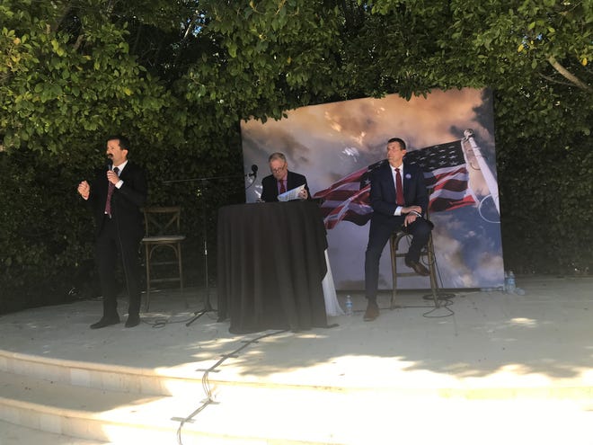 Ventura County Sheriff Bill Ayub, left, debates sheriff candidate Cmdr. James Fryhoff, right, Saturday in Moorpark. Buzz Patterson, center, moderated the debate.