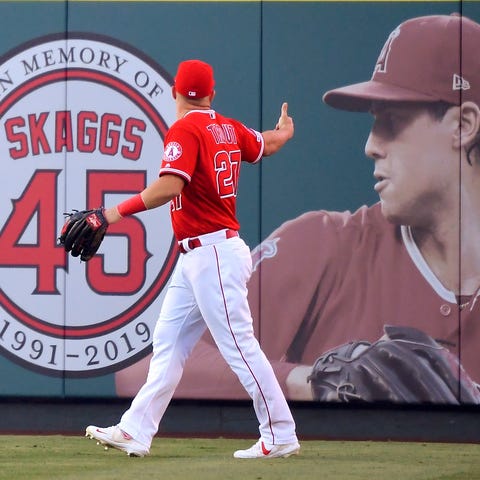 Angels center fielder Mike Trout gestures toward a