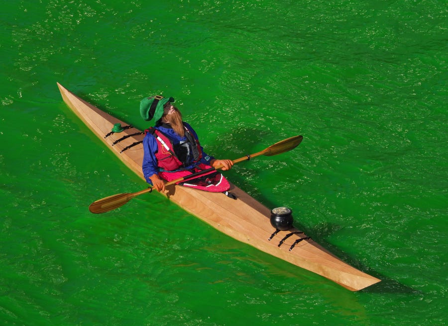Kayakers make their way up the Chicago River on March 16, 2019, after the river was dyed green in celebration of St. Patrick's Day.