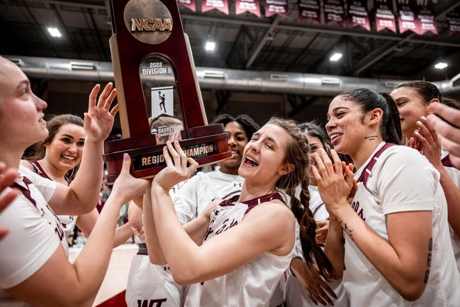 WT's Zamorye Roberts (11, center) lifts the NCAA Reginoal Champion trophy after the Lady Buffs defeated Lubbock Christian 59-54 in the South Central Regional Championship on Monday, March 14, 2022 at the First United Bank Center in Canyon.