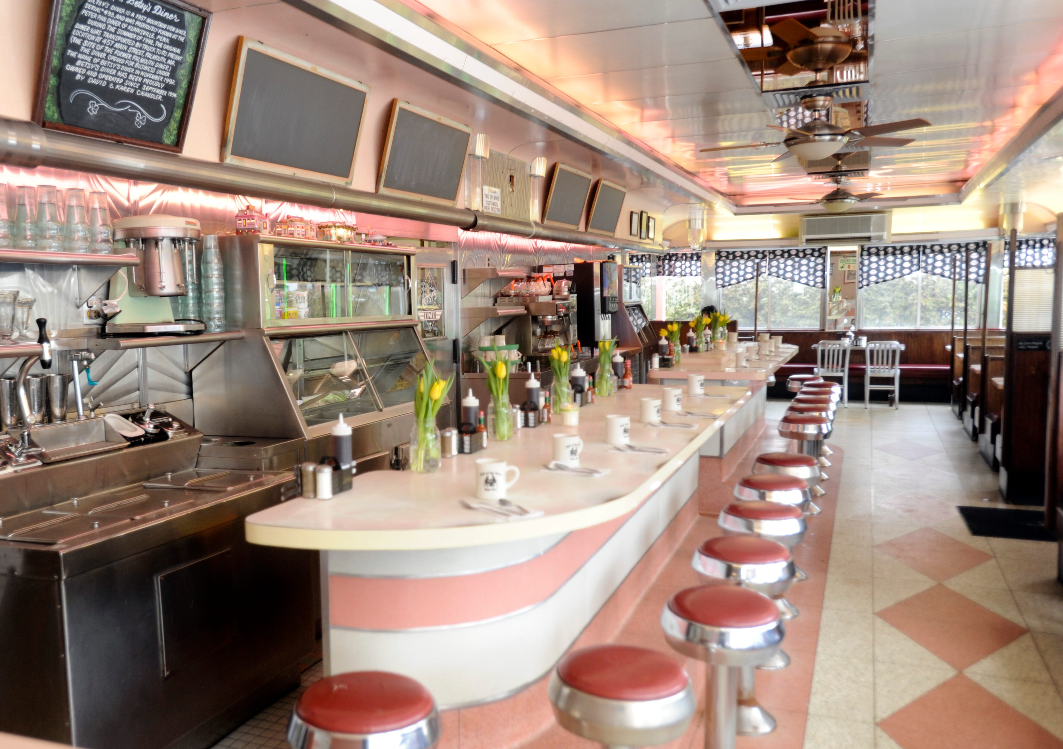 A long old-fashion diner counter but all pink