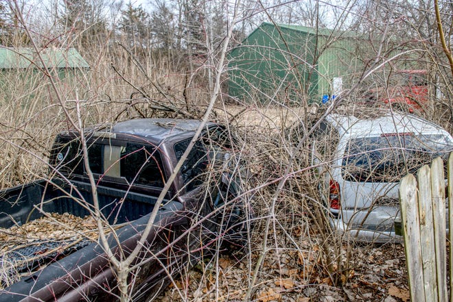 Dilapidated vehicles sit on property at 22330 Farmdale Road in East Peoria.