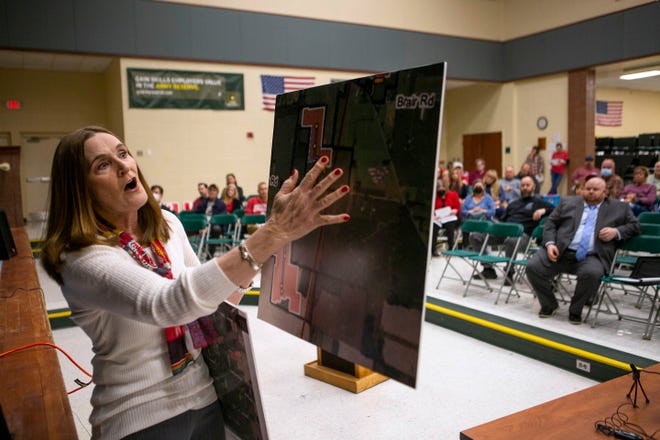 Paula Derflinger, a Hartford Township resident opposed to the Harvey Solar project in northwest Licking County, shows the Ohio Power Siting Board a map and tells them she will be surrounded by solar panels during Monday's public hearing at Northridge High School.