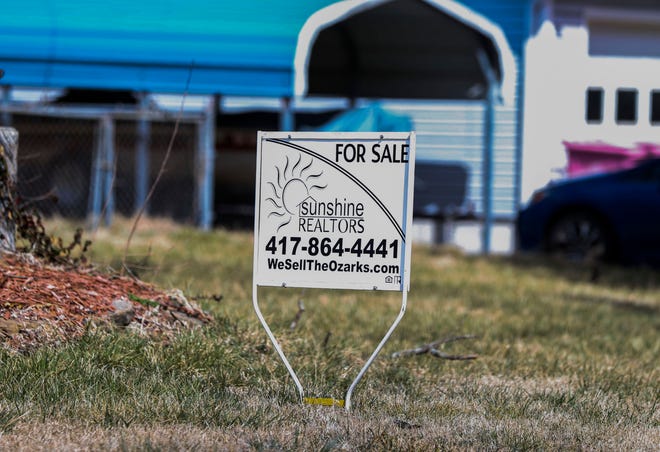 A "For Sale" sign in front of a house on Tuesday, March 15, 2022.