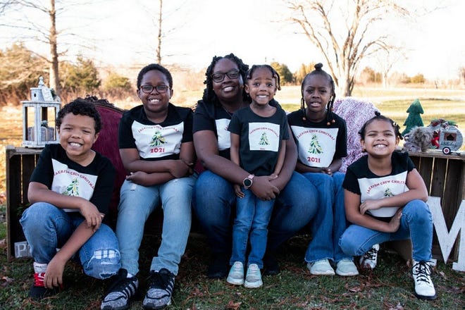 Bloomington mother Eliza Carey sits with her children, Matthew, 10, C.J., 12, Makayla, 3, Jaida, 14, and Raelynne, 7. A paraprofessional at Templeton Elementary School, Carey is working to get her teaching license.