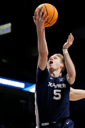 Xavier Musketeers guard Adam Kunkel (5) drives to the basket in the second half of the NIT First Round game between the Xavier Musketeers and the Cleveland State Vikings at the Cintas Center in Cincinnati on Tuesday, March 15, 2022. Xavier advanced in the tournament with a 72-68 win over the Vikings.