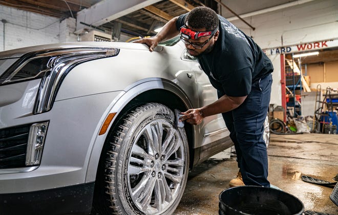 Daviant Palmer, 27, of Detroit, details cars in his Detroit shop Dae's Detail Friday, Feb. 25, 2022. Palmer can now detail cars full-time thanks to he and his mom, Typhany Jones, 45, of Detroit having success posting his work on TikTok, the popular social media platform that allows users to make creative short videos and market themselves as influencers.