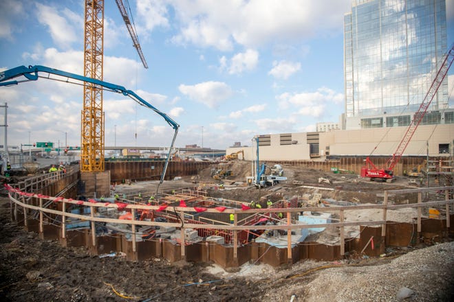 Concrete is poured to establish the foundation at the Couture construction site in Milwaukee on Wednesday, March 16, 2022. The $188 million Couture project, at 909 E. Michigan St. on the lakefront, is expected to feature 322 high-end apartments, 42,600 square feet of restaurant and retail space, and a transit concourse for The Hop and the East-West Bus Rapid Transit.