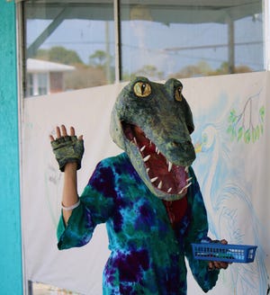 Joan Matey dons alligator mask at previous Carrabelle Culture Crawl, set for March 19, 2022.