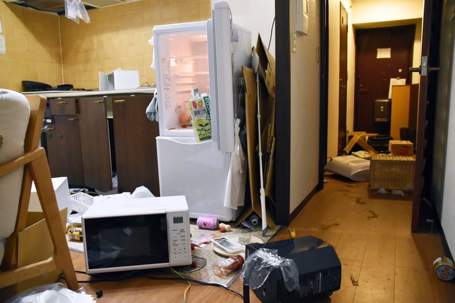 Furniture and electrical appliance are scattered at an apartment in Fukushima, northern Japan Wednesday, March 16, 2022, following an earthquake. A powerful earthquake shook off the coast of Fukushima in northern Japan on Wednesday, triggering a tsunami advisory.