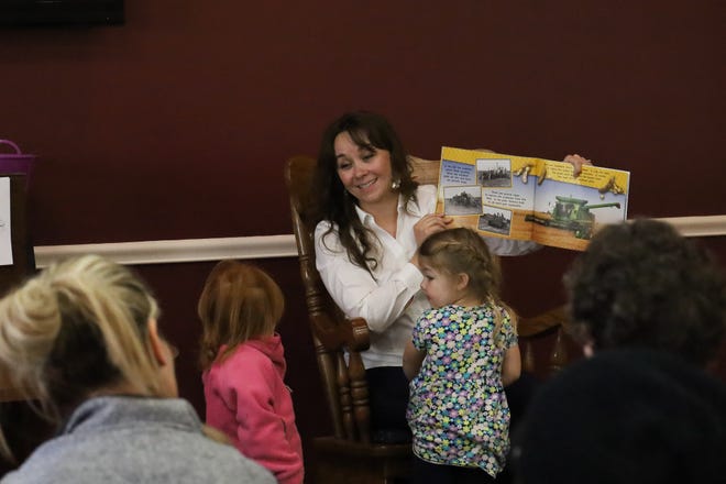 Amanda McDowell, a Lawrence County farmer, shows the audience a page from Katie Olthoff's "My Family's Soybean Farm." The book is a part of the Beaver-Lawrence Farm Bureau's educational tools for younger children to help them learn about farming.