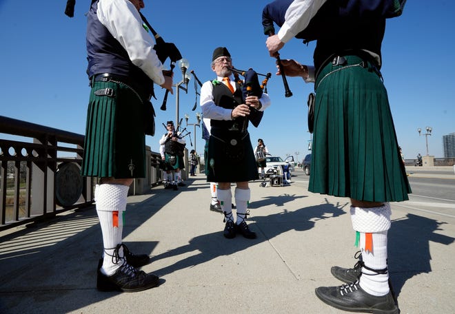 Bagpiper Glenn Mackie warms up with the Shamrock Club of Columbus Pipes and Drums before marching in the St. Patrick's Day parade through Downtown on Thursday. The parade returned this year after a two-year hiatus due to the COVID-19 pandemic.
