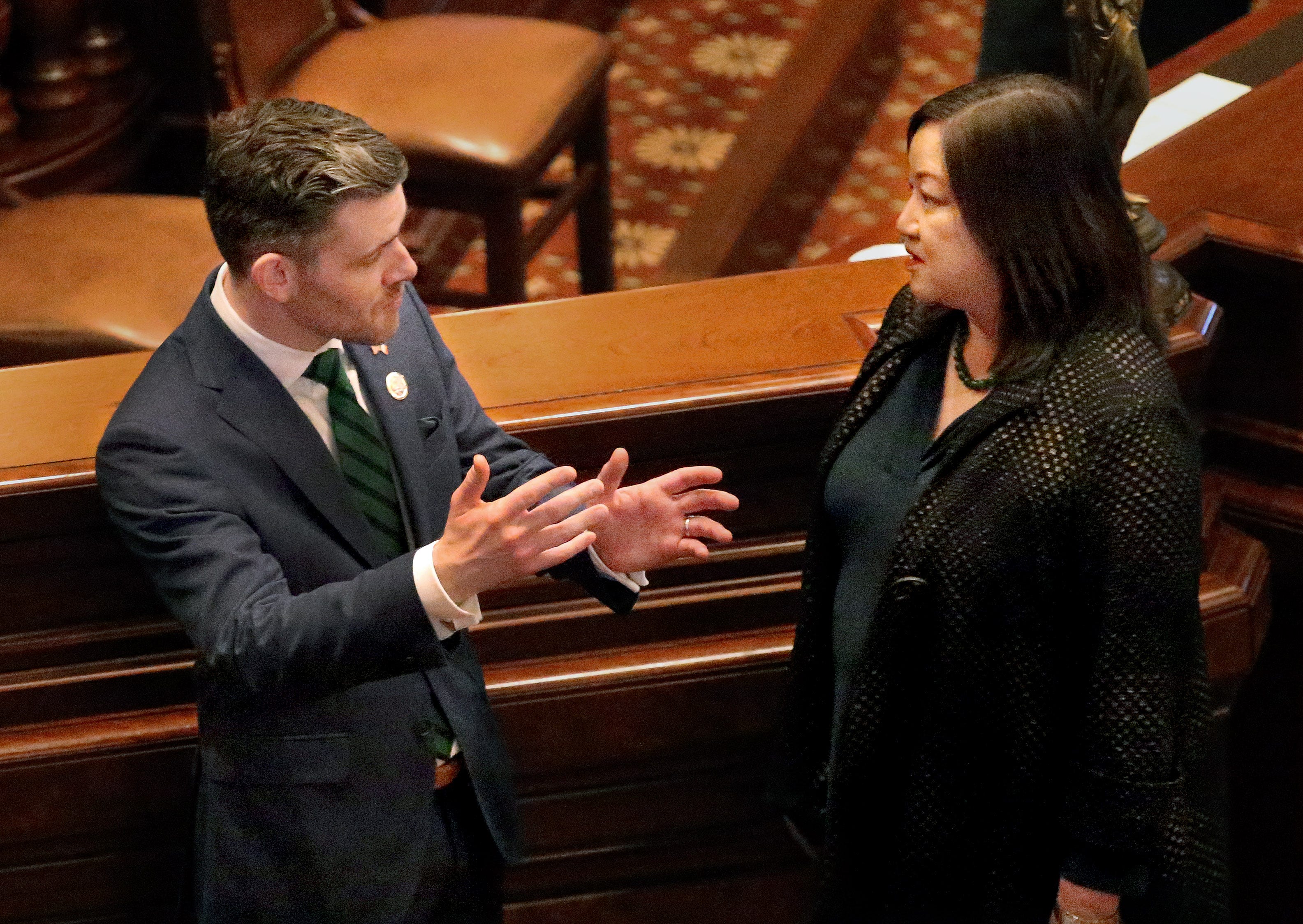 Kevin Byrne, consul general of Ireland to the Midwestern United States, talks Thursday with state Rep. Theresa Mah, D-Chicago, on the House floor. [Thomas J. Turney/The State Journal-Register]