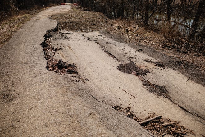 A section of Waterworks Road Hill SE is seen closed due to erosion issues and roadway collapse, Thursday, Mar. 17, 2022 in Mill Township.