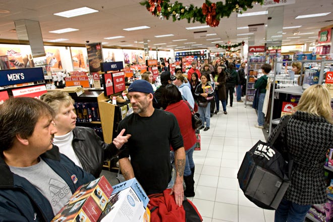 November 28, 2008 Photographs from Southridge Mall  as shoppers head to the mall for stores opening at 4am and then 5am.  From left to right, Mike Dziedzic of Greenfield, Lisa Konitzer of Milwaukee and Jeff Peaslee of Greenfield wait in the checkout line at the Kohl's store in Southridge.  The store opened at 4am. MICHAEL SEARS/MSEARS@JOURNALSENTINEL.COM
