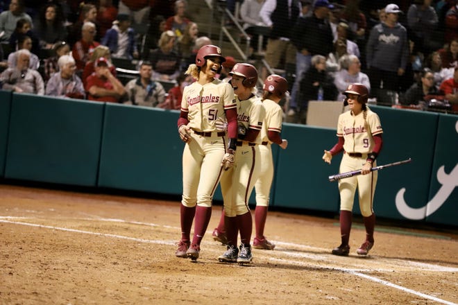 The Florida State softball team celebrates Michaela Edenfield's three-run home run in the No. 2 Seminoles' come-from-behind 6-4 win at No. 4 Alabama on Wednesday, March 16, 2022.
