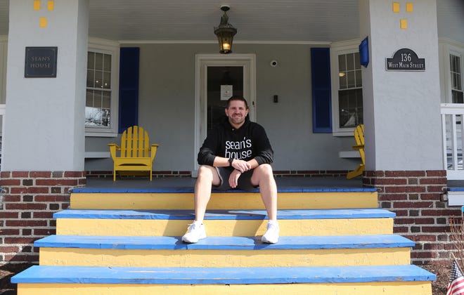 Scott Day, Executive Director of Sean's House, sits on the front steps of Sean's House located at 136 W. Main St. in Newark. The site is a safe haven for teenagers and college students.