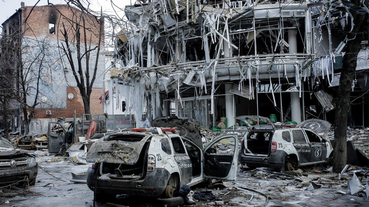 Damaged vehicles sit among debris in Kharkiv, Ukraine.